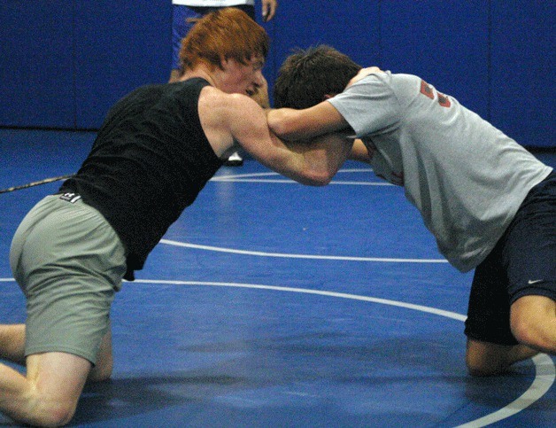 Montana Johnson squares off with teammate Kyrell Broyles during wrestling practice. Both are part of coach Jim Thompson’s goal to send Falcons to state.