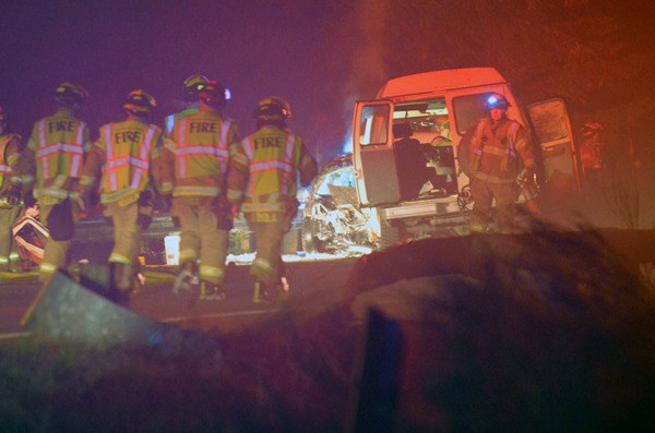 South Whidbey Fire/EMS firefighters walk the scene of a fatal two-car crash on Highway 525 in February. Tim Keil died at the scene and the driver