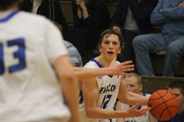 Falcon senior Chase White looks for an open man against defensive pressure by the Eagles.