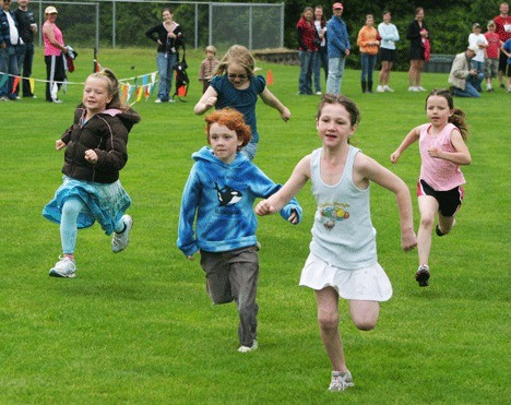 A group of young folk race for glory Sunday morning during the Fry Run following the 14th-annual running of the Chum Run at South Whidbey Community Park. Every kid who ran was given a medal.