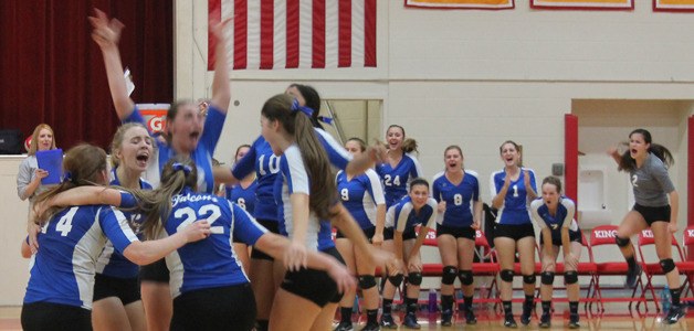 South Whidbey’s volleyball team celebrates after recording the match-winning point on a block by junior Morgan Davis