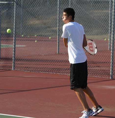 Falcon Brendan Riley concentrates on his backhand during a recent practice at the high school courts.