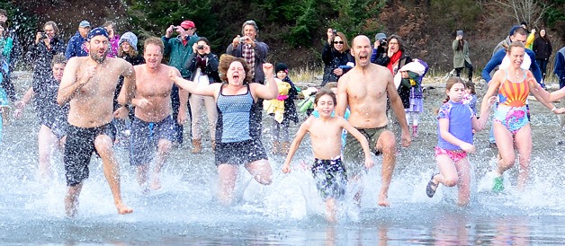 Participants of the 10th annual Polar Bear Plunge charge the waters of Puget Sound Wednesday at Double Bluff beach park. With 190 swimmers