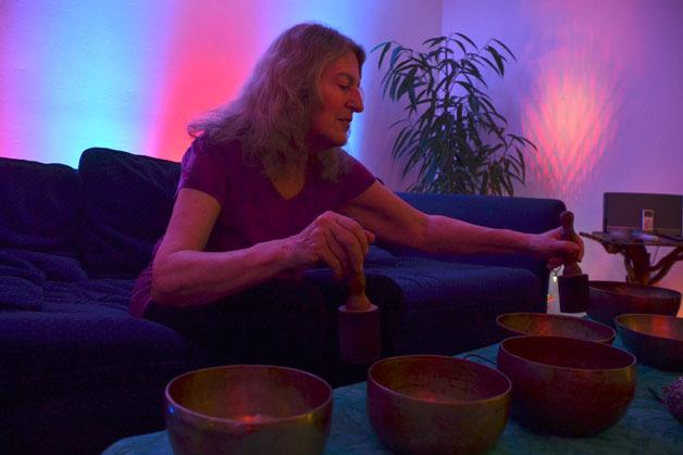 Clinton resident Barb Nichols plays a Tibetan singing bowl in her new space