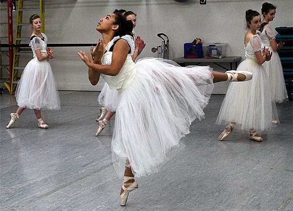 Faith O’Brochta and fellow “Giselle” dancers practice choreography during a brief impromptu rehearsal Monday evening following their modern dance class. The girls put on their ballet attire over their modern dance clothes.