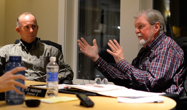 Port of South Whidbey Commissioner Curt Gordon listens to Commissioner Ed Halloran during a special meeting Wednesday in Freeland. The board agreed