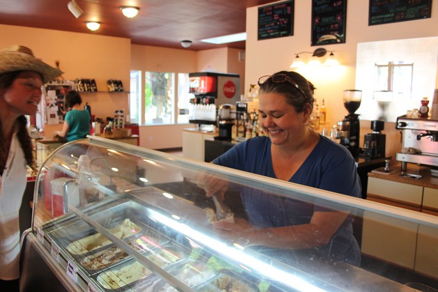 Mona Newbauer drops a scoop of gelato into a cup during a recent warm day at the chocolate boutique in Langley