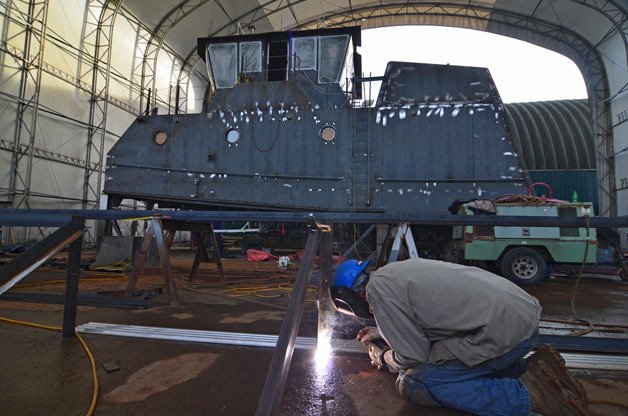 Journeyman fitter Troy Hawkins works on a jig at Nichols Brothers Boat Builders in Freeland. The shipyard has landed three contracts.