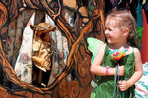 Nymbol enchants a young faerie at Faerieworlds Mythic Fair in Eugene
