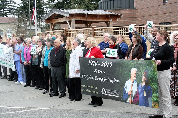 Whidbey General Hospital staff and board directors gather in front of the entrance to celebrate 45 years in operation.