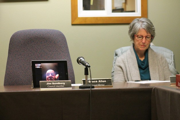 Councilman Jim Sundberg listens to the Langley City Council meeting Monday from Ann Arbor