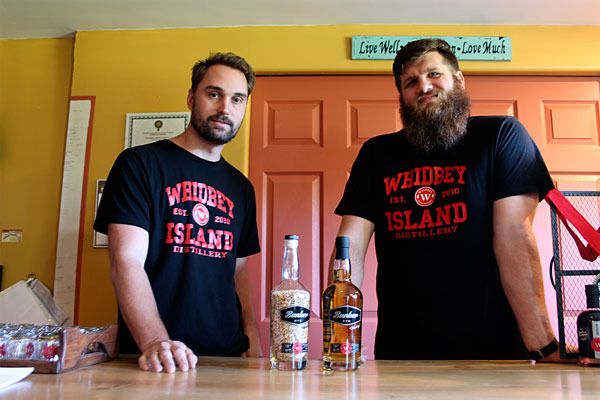 General Manager of Whidbey Island Distillery Mike Huffman (left) and senior distillation engineer Jonathan Bower (right) show off their rye whiskey. The rye is in high demand