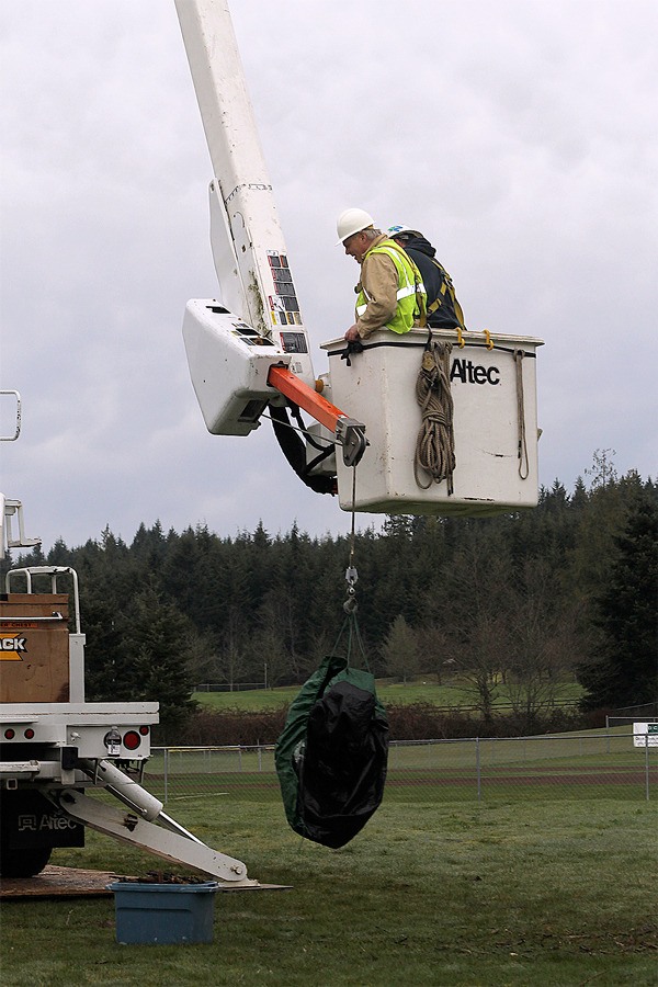Jim Kaiser of Osprey Solutions puts together an osprey nest platform near Waterman’s Field at South Whidbey High School on March 20.