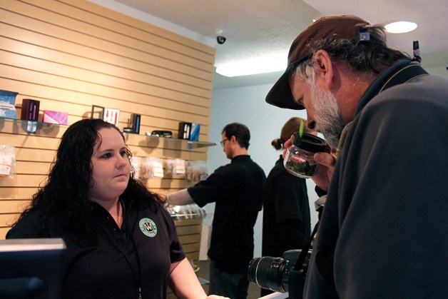 Tom Trimbath takes a whiff of weed at Whidbey Island Cannabis Company on the recreational marijuana store’s first day of operation Friday.