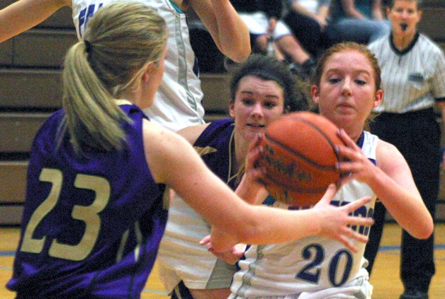 South Whidbey junior Madi Boyd drives inside the key against Friday Harbor senior Jean Melborne on Saturday. Boyd helped steady the Falcons’ offense after an error-filled start.