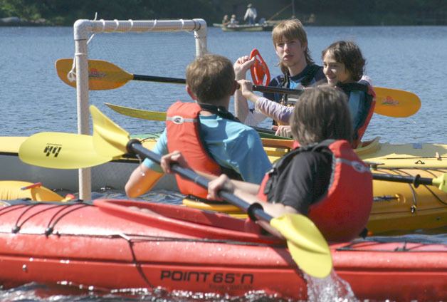 Nathan Lux of Clinton winds up to whip the disc into the goal during a game of kayak Frisbee. The 16-year-old was an ace at the game during the parks district’s camp.