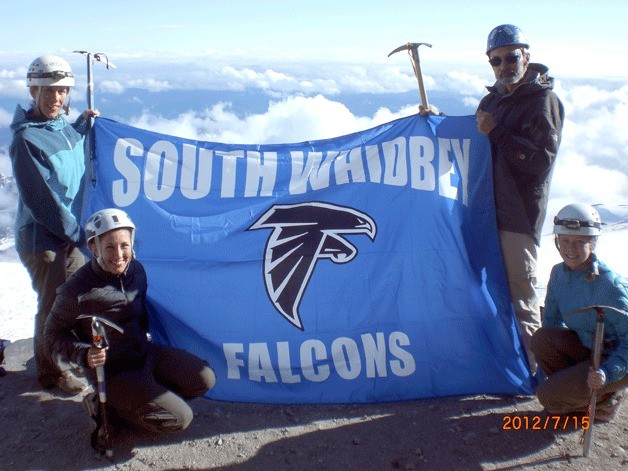A flock of proud Falcons represent South Whidbey High School with a school flag after reaching the summit of Mount Rainier. Clockwise from top left are Jen Baker