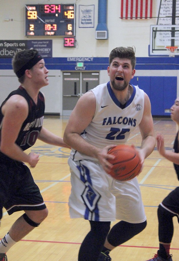 Falcon senior Mo Hamsa eyes the rim for a layup against Cedarcrest senior Adam Davenport on Feb. 3.