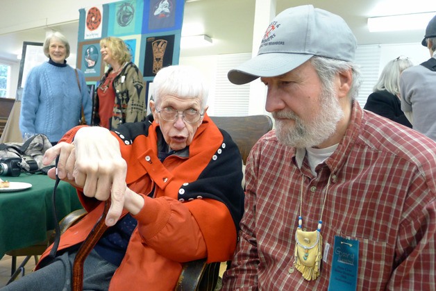 Coupeville artist Roger Purdue receives a button blanket and cedar hat from representatives of the Samish Tribal Nation. Purdue has spent more than 20 years designing the logo for the Penn Cove Water Festival.