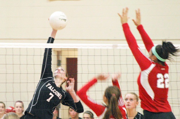 Falcon senior hitter Linden Firethorne hits a kill against King’s hitters Mady De Genner and Joclyn Kirton on Thursday night. She finished with 14 kills in the three set loss.