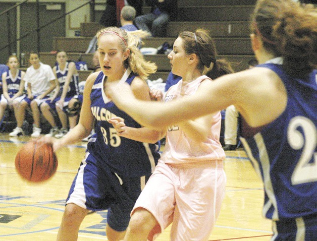 Hayley Newman curls the perimeter as she tries to get free of Lakewood senior Jordan Wessell. Newman scored a game-high 12 points in a 41-35 loss for the Falcons.