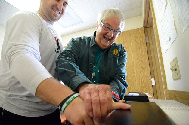 Clinton resident C.J. Baker gets his fingerprints taken with the assistance of Ham McKelvey with the Island County Sheriff’s Citizen Patrol. Baker recently got a job at an East Coast university