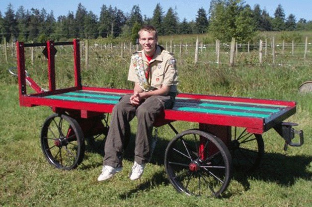 Eagle Scout candidate Alex Bowers of Freeland sits on Greenbank Farm’s wine wagon