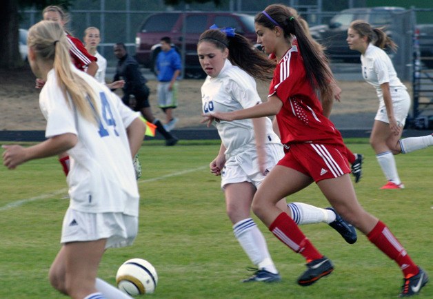 Falcon freshman Annie Lux chases Lady Knight Beth Stella in the first half Tuesday. King’s won the Cascade Conference match with South Whidbey