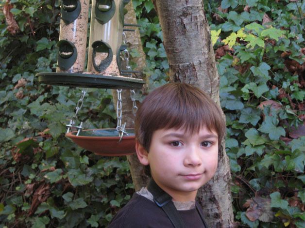 Corbin Klaft stands in front of the bird feeders that hang outside his room; a perfect spot for viewing birds.
