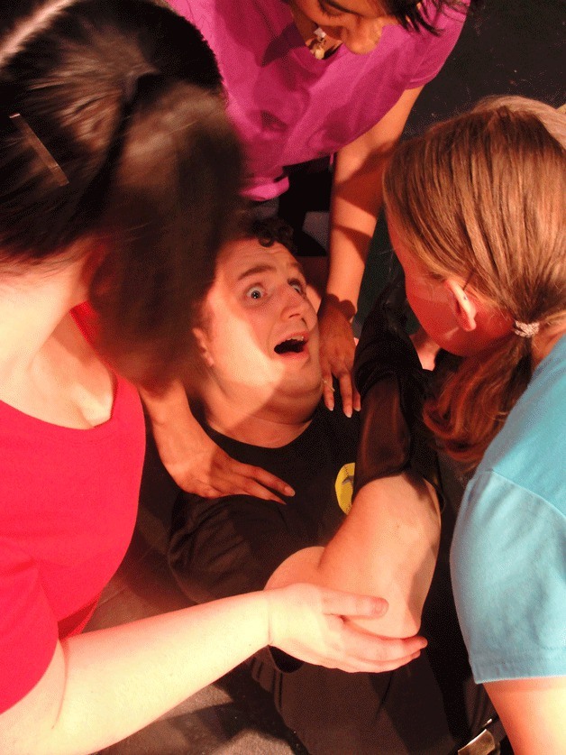Captain Hammer (Michael Morgen) is swarmed by groupies during a rehearsal for 'Dr. Horrible's Sing-Along Blog' at WICA.