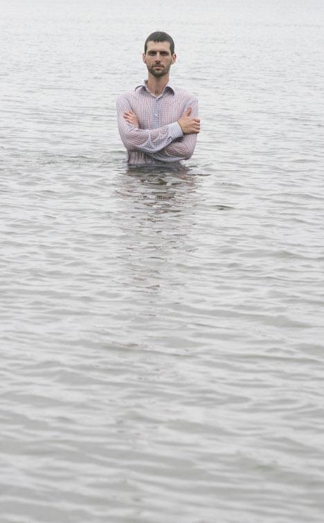 Corey Graves stands in the waters of Saratoga Passage by Seawall Park. The local barista will lead an effort to form a human chain off the shore of Langley on Saturday to draw attention to the harmful impacts of U.S. oil dependence.
