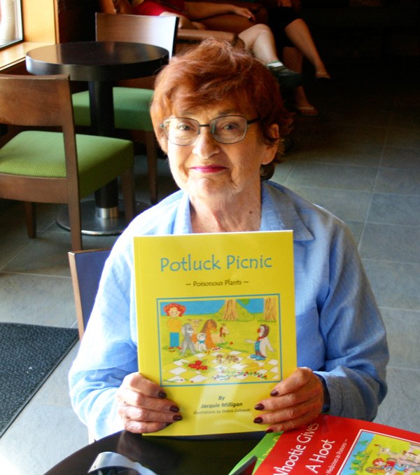Jacquie Milligan holds a copy of her recently re-published children’s book