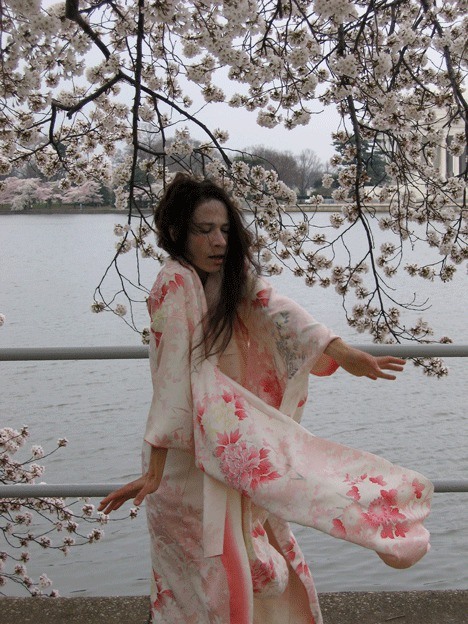 Maureen Freehill practices Butoh under a flowering cherry blossom tree in Washington