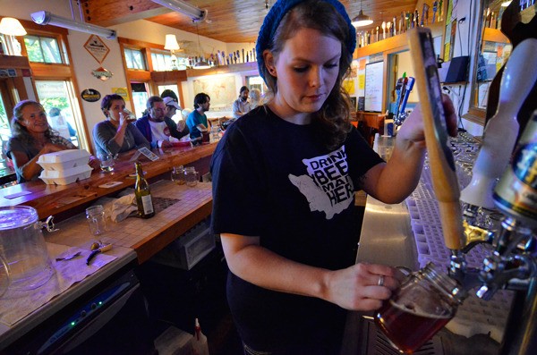 Tiffany Cortez pours a beer at her business
