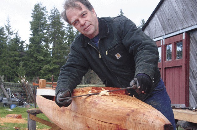 Brad Rice works on a South Seas dugout canoe at his Freeland boat shop: 'It's kind of fun to go out in the woods and find a tree and get a boat.'