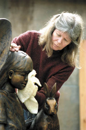 South Whidbey sculptor Georgia Gerber does the final buffing and waxing of her latest sculpture