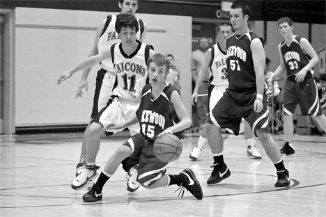 Falcon Chris Carey demonstrates defensive zone coverage as he guards Cougars Max Dragich and Cameron Fry during Fridays win.