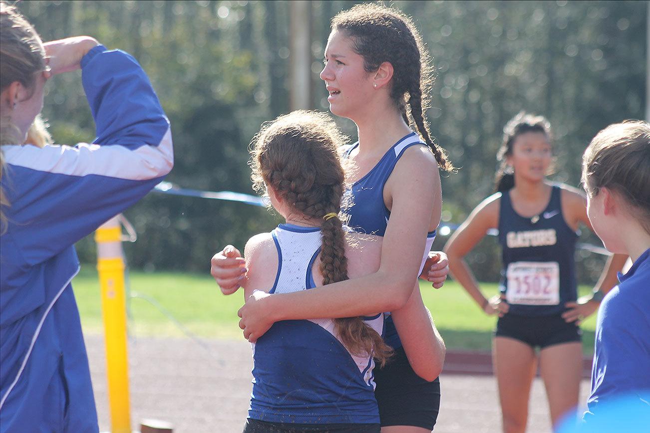 Evan Thompson / The Record South Whidbey cross country runners Flannery Friedman and Sophia Morgan embrace after qualifying for the Class 1A state championships.