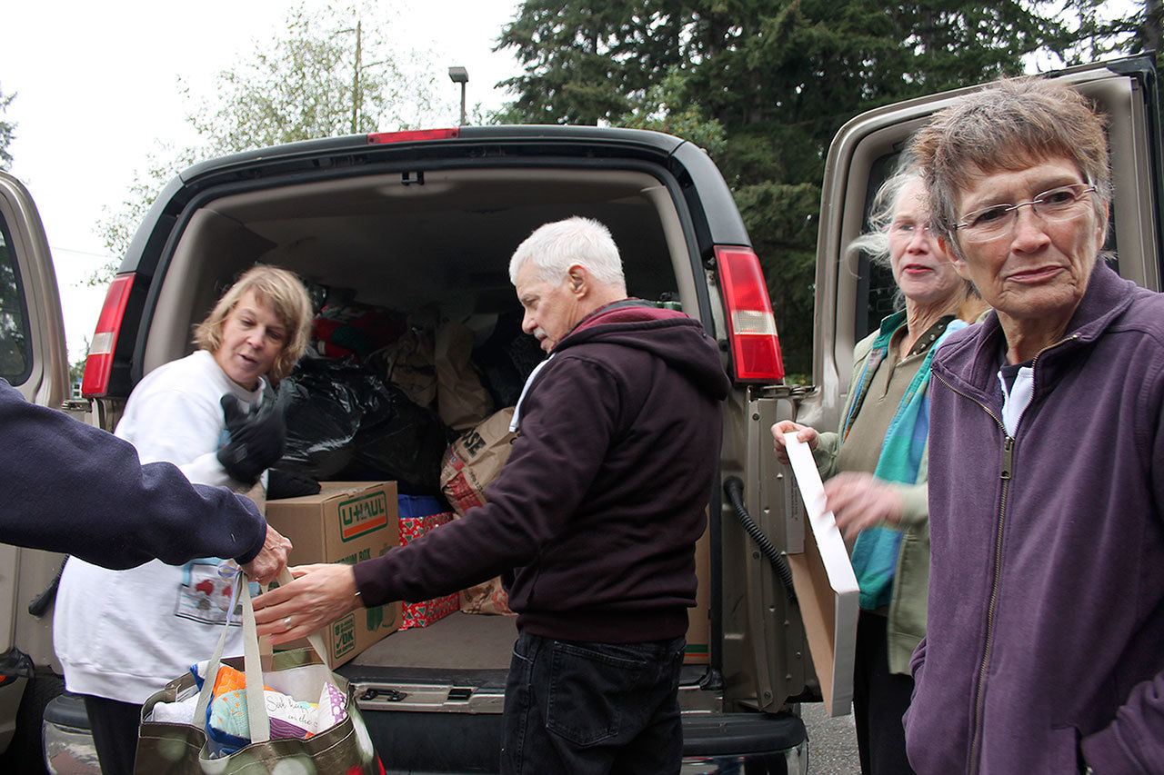 Kyle Jensen / The Record Volunteers from Trinity Lutheran Church and St Hubert Catholic Church fill a van with gifts for patients at Western State Hospital.