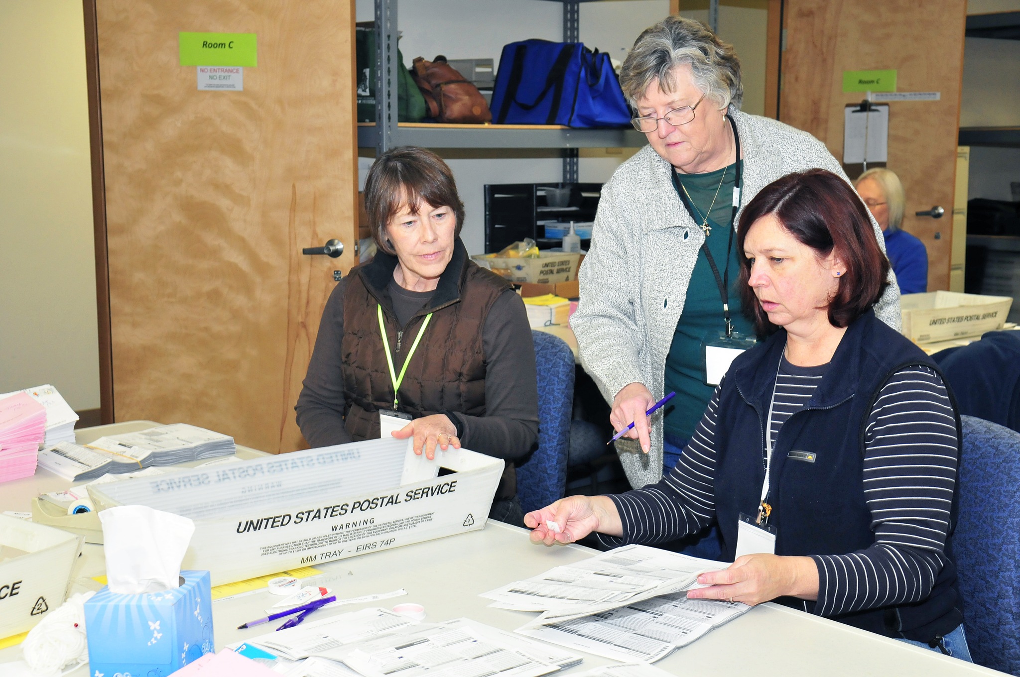 Casie Horr, Maggie Paczaowski and Toni Craggs process ballots in Coupeville Monday. The first batch of General Election results were released Tuesday evening.
