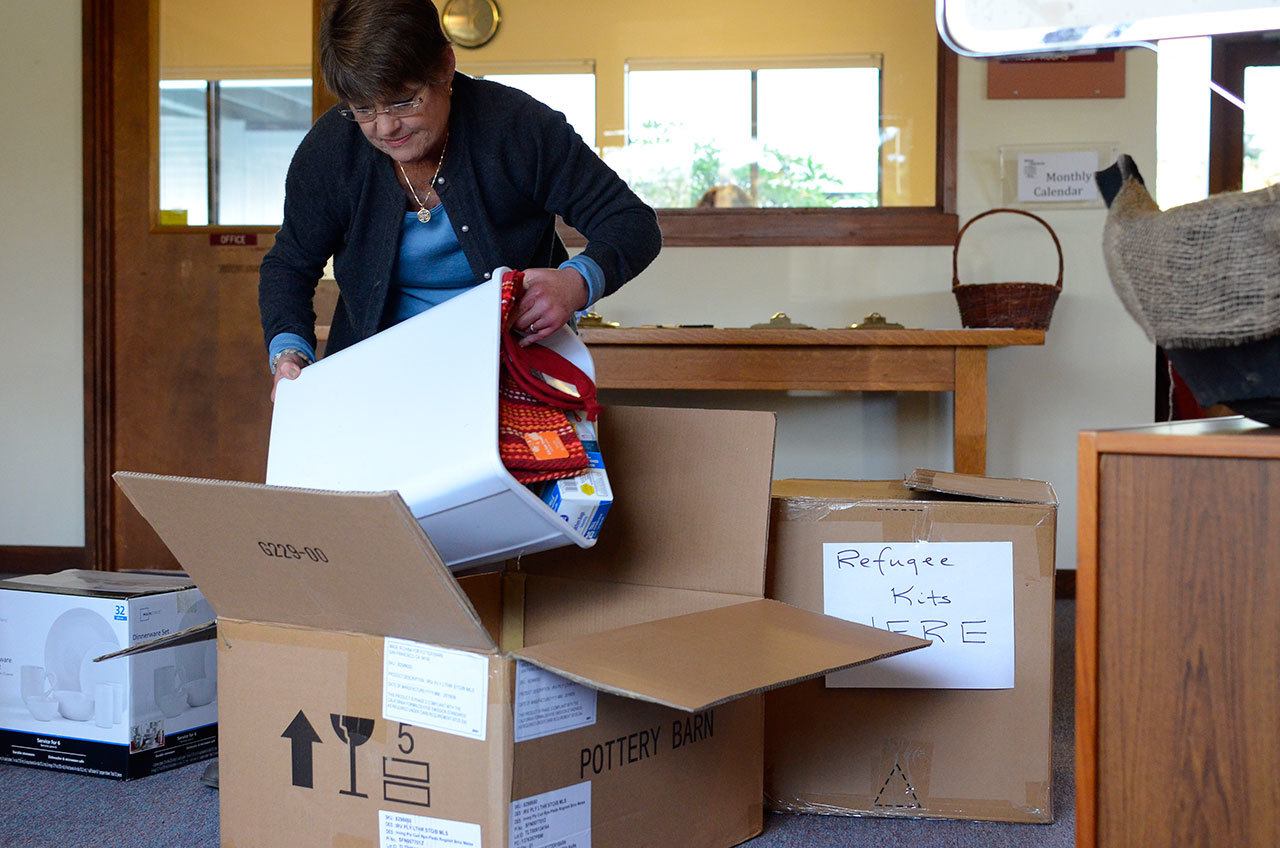 Nancy Roger looks through donations to the grass roots program she created, South Whidbey Refugee Project.