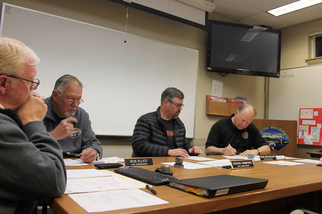Kyle Jensen / The Record South Whidbey Fire/EMS commissioners sign off to approve the 2017 budget.