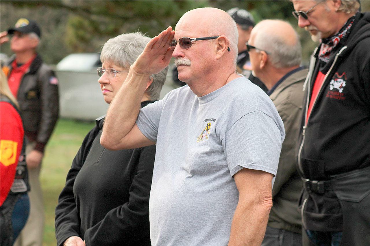 Evan Thompson / The Record                                Ken Goff, a Freeland resident and Vietnam combat veteran, salutes the flag during a Veterans Day ceremony on Friday morning at Bayview Cemetery.