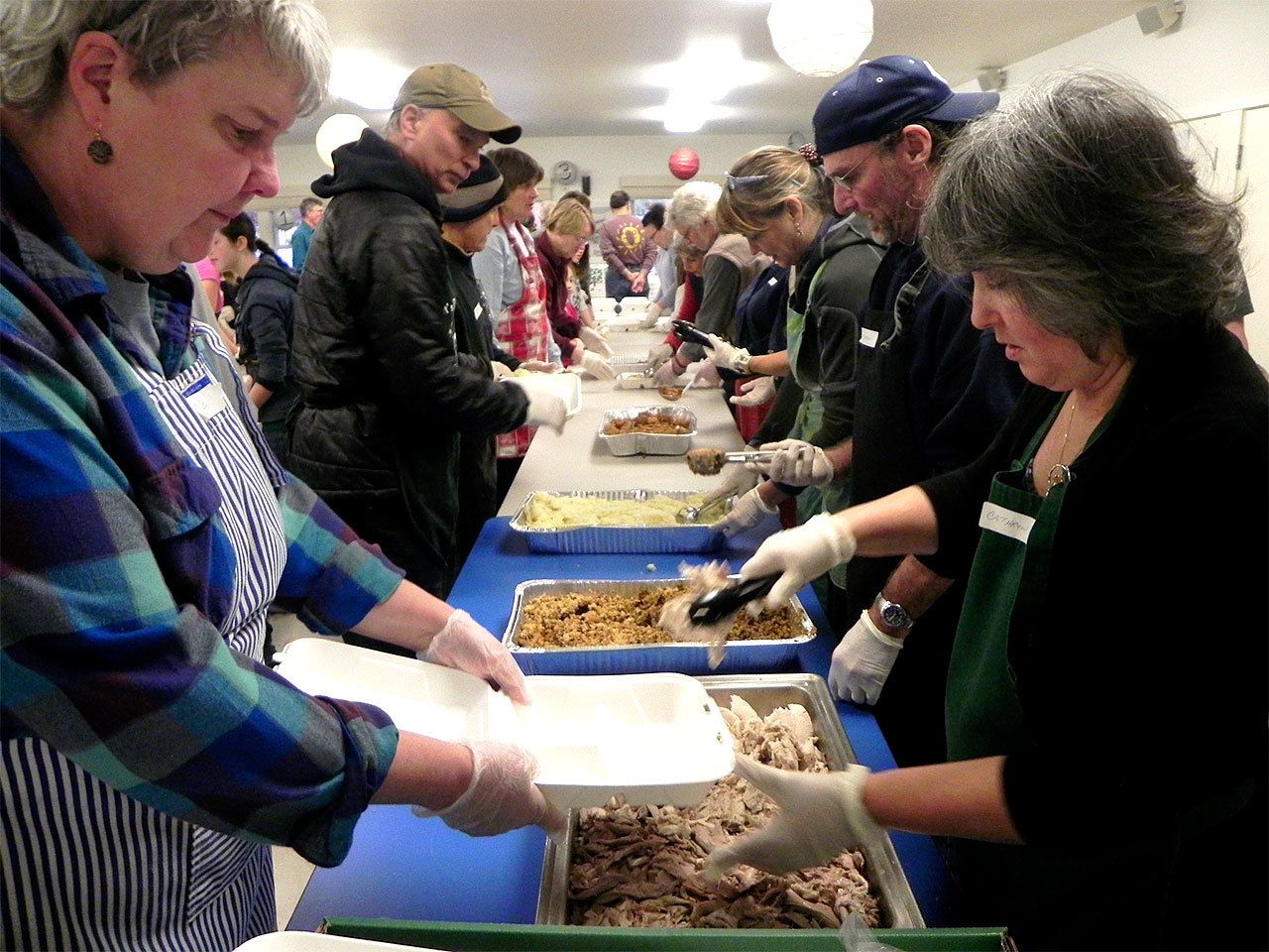 Record file                                A long line of volunteers packages dinners for those who otherwise wouldn’t eat Thanksgiving.