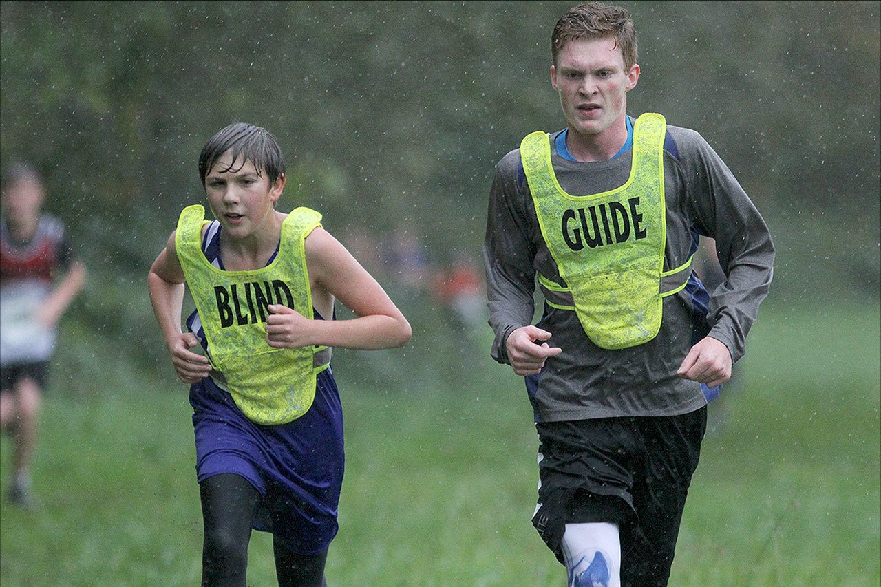 Matt Simms photo                                Langley Middle School eighth-grader Luke Gandarias (left) competes in cross country despite being blind since the age of seven. To his right is guide runner Cedar Rossel, a student at South Whidbey High School.