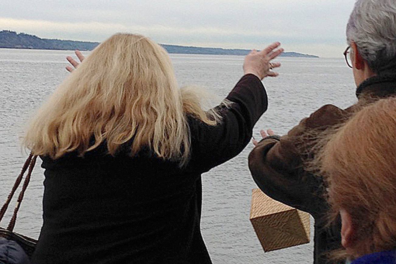 Contributed photo Members of Hunziker’s family toss a biodegradable box containing Hunziker’s ashes off a ferry on the Mukilteo-to-Clinton route.