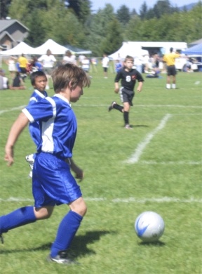 U-10 player Bryce Arburn addresses the ball during a tournament against Issaquah last week with Artie Condor in the background. The South Whidbey Youth Soccer Club hosts SoccerFest 2007 Saturday at the soccer field complex on Langley Road.