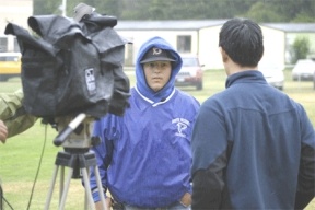 Colton Wilson is interviewed in the outfield by a television news team from Seattle Saturday. A volunteer work party got together to make Wilson's wish a reality.