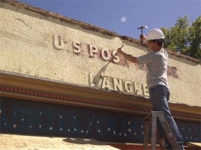 Gemkow workers uncover the old post office sign during their remodel work on First Street in Langley.