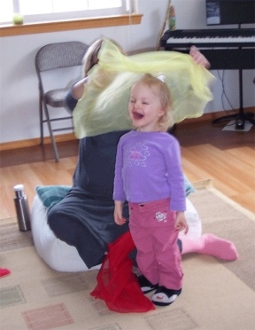 Maddy Racicot expresses her joy in the creative movement portion of a "Music Together" class with her mom.